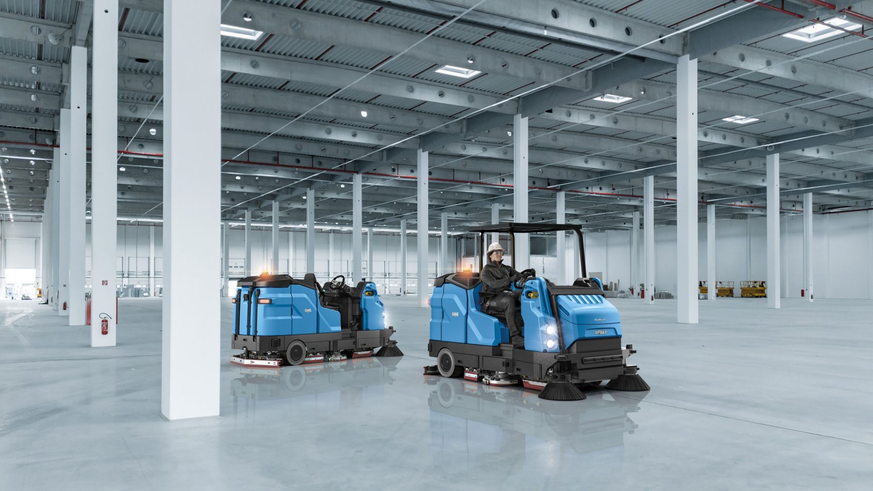 Two combination machines with overhead guards parked in a warehouse