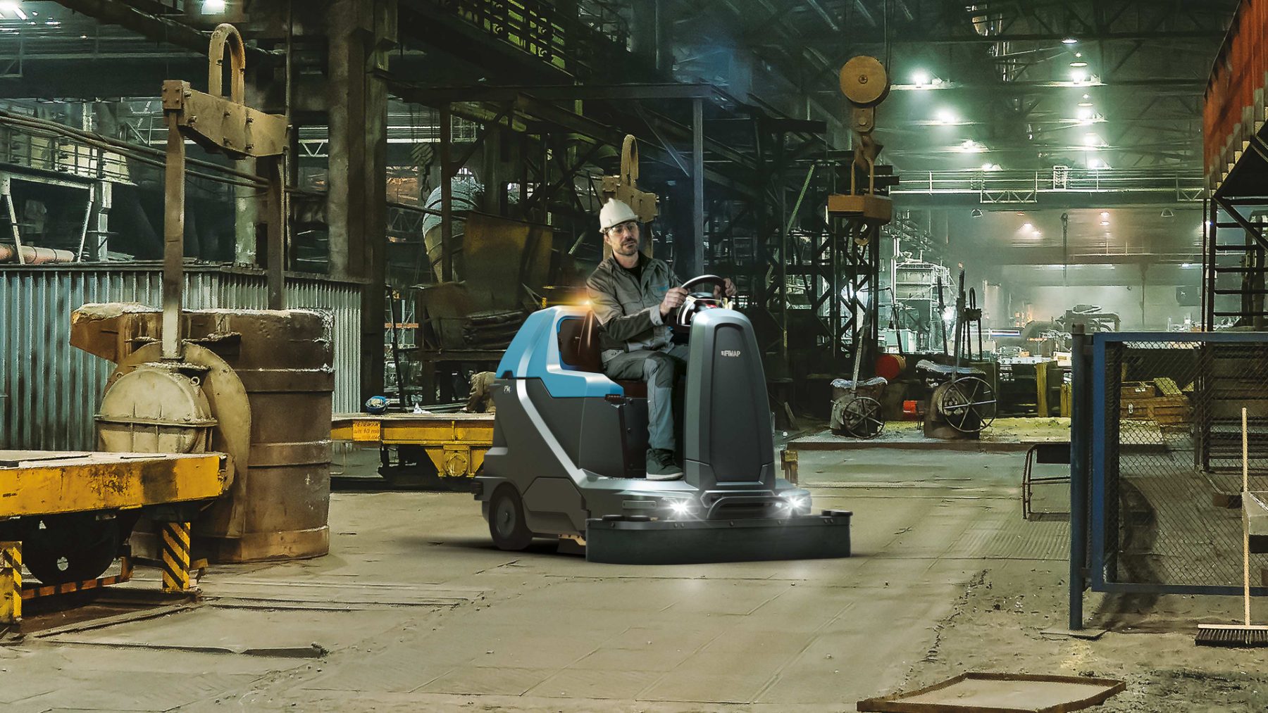 Operator sweeping a foundry floor where dust control matters