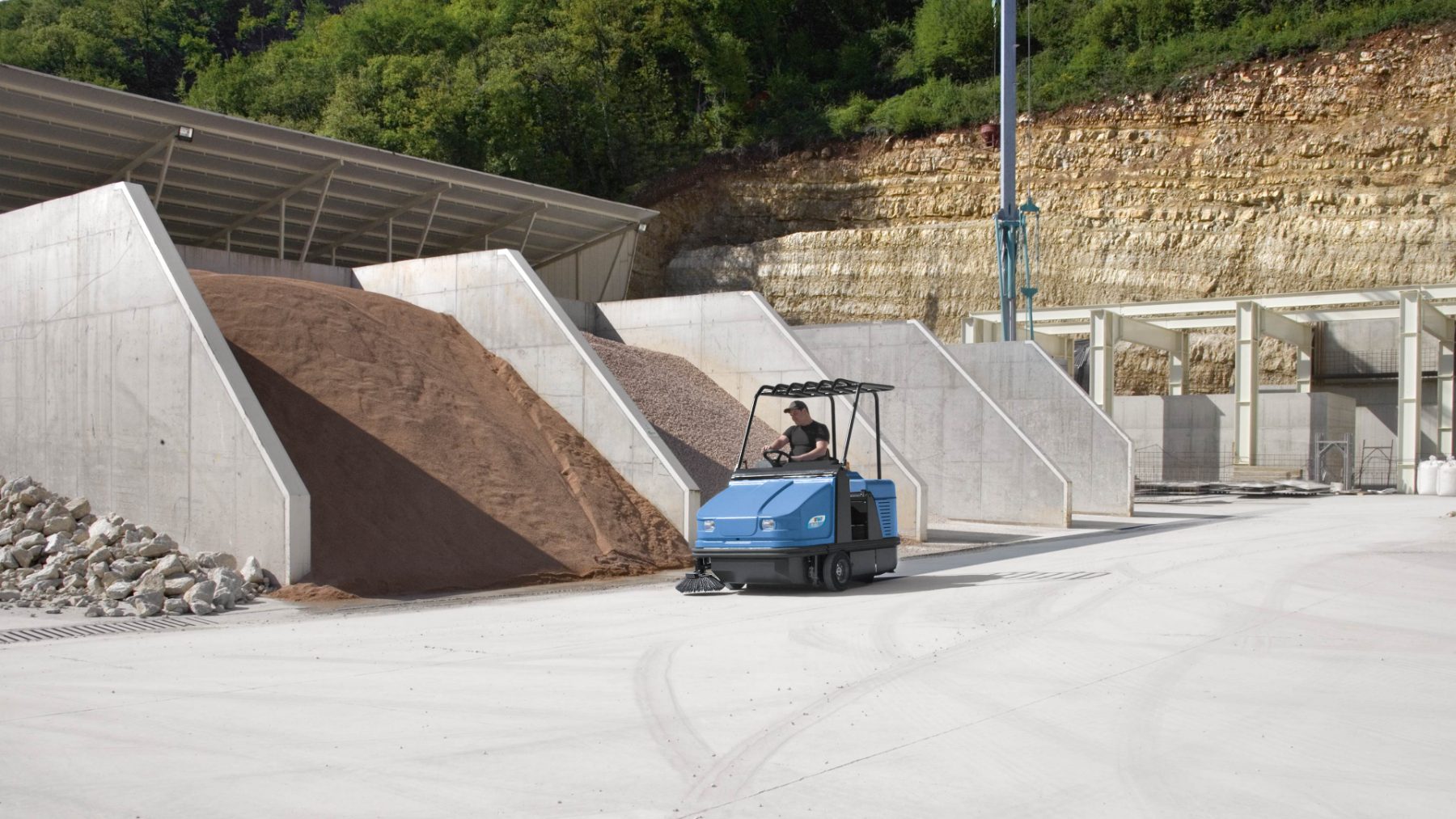 Industrial sweeper working quarry hardstand