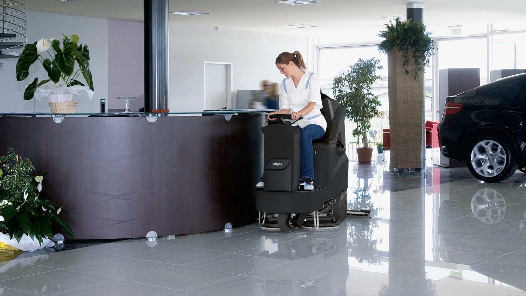 Operator scrubbing a showroom reception floor to a high gloss