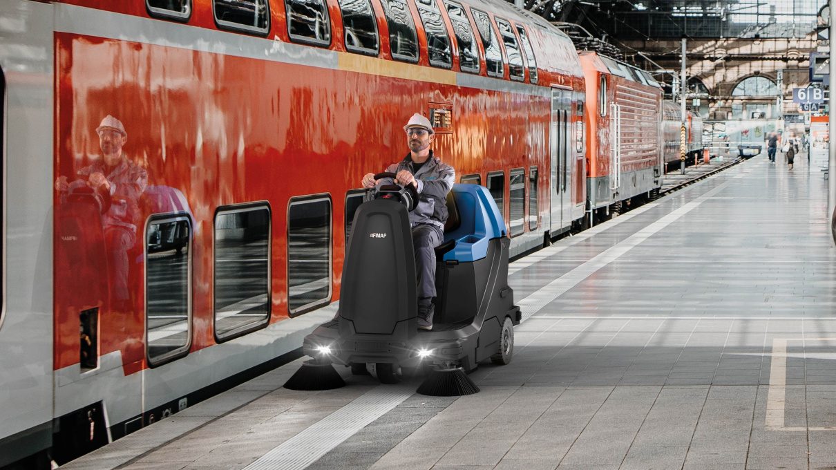 Ride-on sweeper covering a long station platform in a single pass